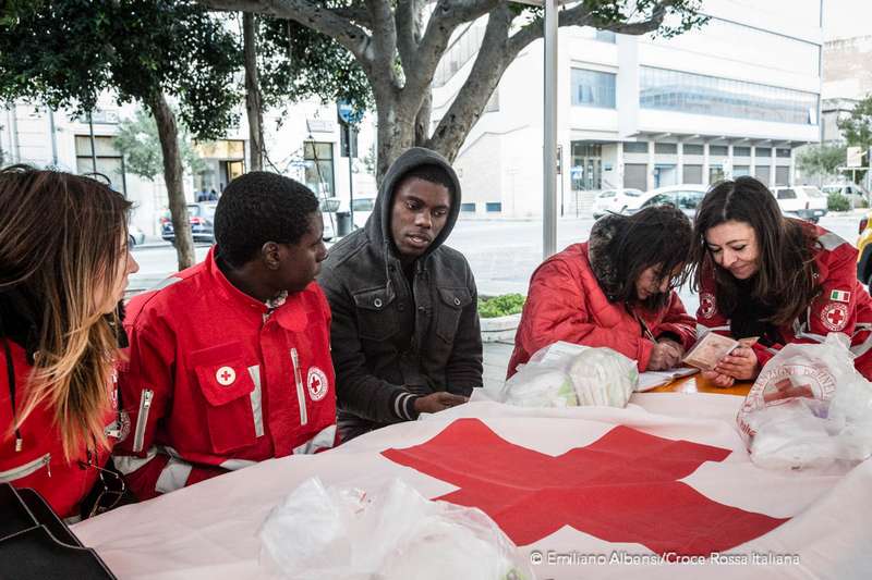 Un ragazzo parla con i volontari e gli operatori di Croce Rossa nel Safe Point allestito a Trapani